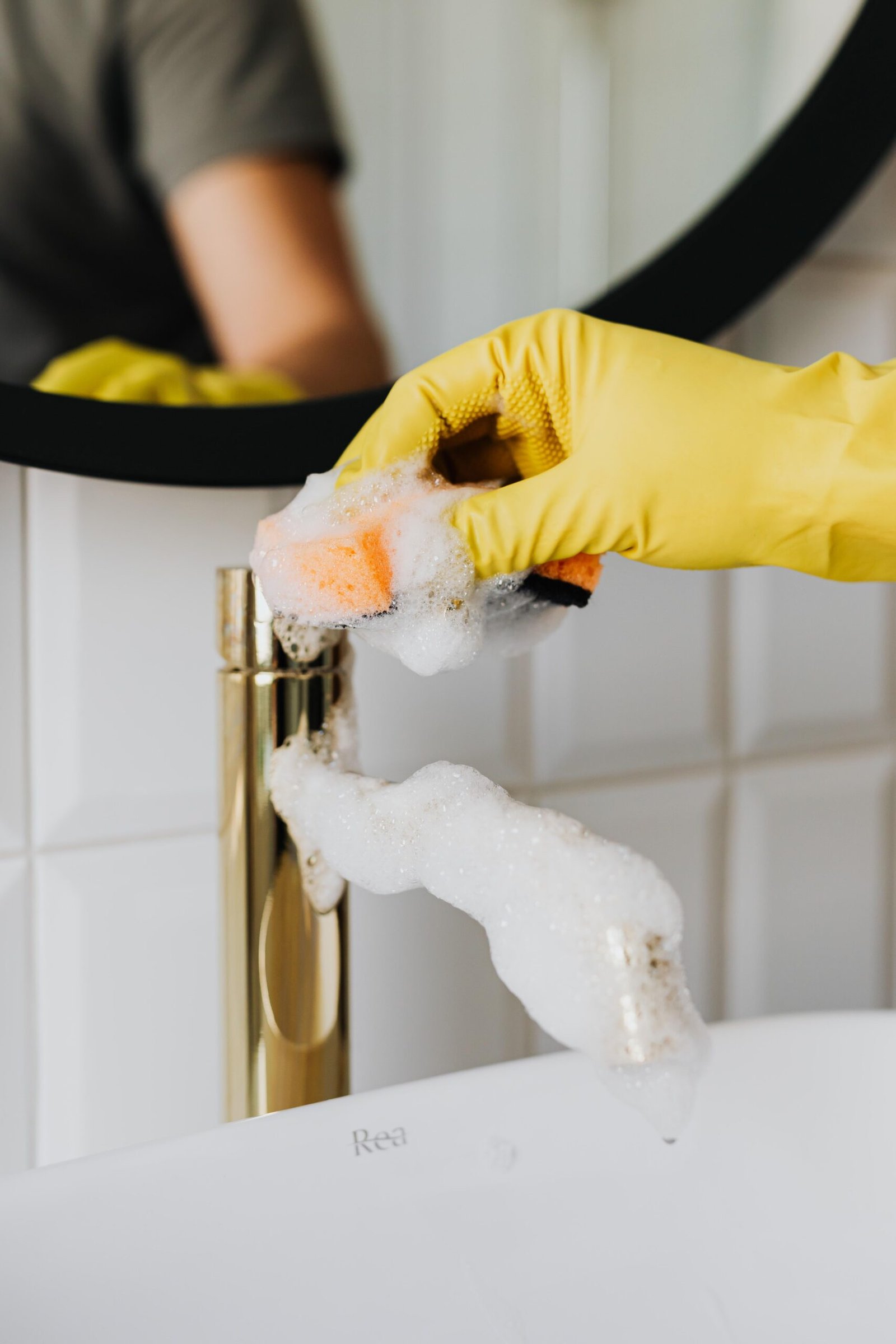 Professional cleaner wiping a kitchen benchtop in a Melbourne home